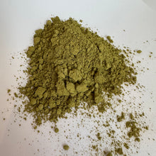 Raw Henna powder Khaki in colour on white background 
